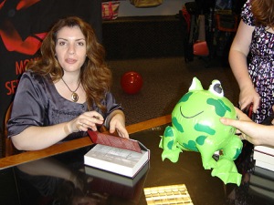 Author Stephenie Meyer signs book.